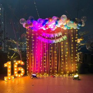 Outdoor Birthday Decoration Kit with LED Marquee Numbers, Curtain Backdrop, and Colorful Balloon Garland.