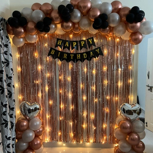 Rose Gold and Black Birthday Decoration Kit with Foil Fringe Curtain, Balloon Garland, and Heart Foils.