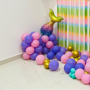 Pink and Purple Mermaid Birthday Decoration Kit with Pastel Fringe Curtain, Balloon Garland, and Mermaid Tail Foils.