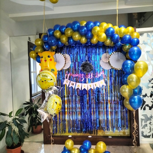 Blue and Gold Pokémon Birthday Decoration with Blue Fringe Curtain and Pikachu Foils.