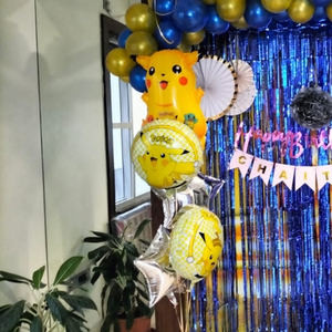 Blue and Gold Pokémon Birthday Decoration with Blue Fringe Curtain and Pikachu Foils.