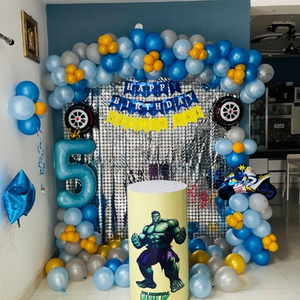 Blue and Silver Superhero Birthday Decoration with Hulk Cutout, Shimmer Backdrop, and Balloon Garland.