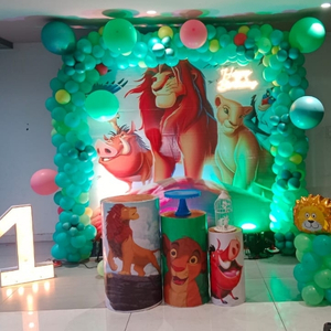 Lion King Jungle Birthday Decoration Kit with Green Balloon Arch, Character Backdrop, and Themed Plinths.