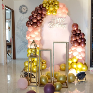 Rose Gold and Peach Balloon Arch with Gold Pedestals
