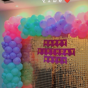 Shimmering Pastel Balloon Arch and Sequin Backdrop
