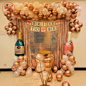Rose Gold Bride-to-Be Balloon Decoration Kit with Sequin Backdrop and Champagne Bottle Foils.
