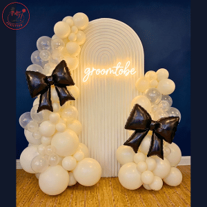 Minimalist Ribbed Arch Backdrop with “Groom to Be” Neon Sign & Oversized Black Bow Accents