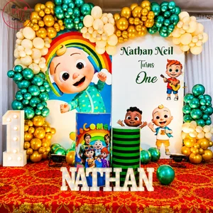 Cartoon themed first birthday decoration with personalized Nathan Neil backdrop, balloon arch, number 1 and NATHAN name display