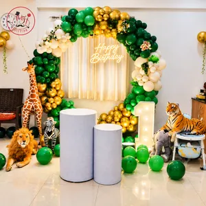 Safari themed birthday decoration with balloon arch, animal props, illuminated Happy Birthday sign, number 1 and decorative stands