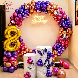 Butterfly themed 8th birthday decoration with grand balloon arch, illuminated Happy Birthday sign, number 8 and decorative display stands
