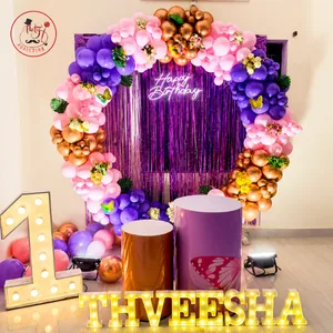 Milestone birthday decoration with grand balloon arch, floral accents, shimmer backdrop, illuminated number 1 and personalized Theveesha name display
