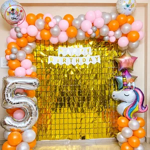 Unicorn 5th birthday decoration with pink orange and silver balloon garland, golden fringe backdrop, unicorn balloon and number 5