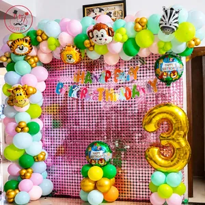 Jungle Safari 3rd birthday decoration with colorful balloon garland, safari animal decorations, sequin backdrop and golden number 3