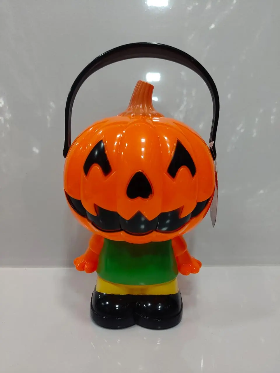 Halloween pumpkin character toy with handle and colorful spooky design